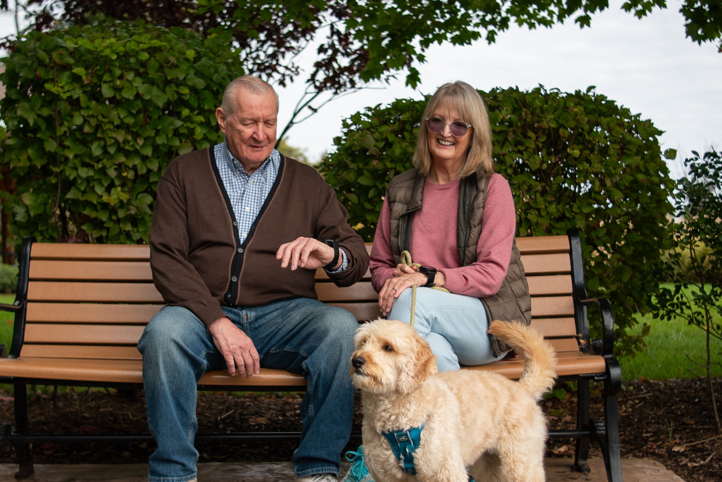 Peaches and couple sitting on bench with lifestation sidekick smart